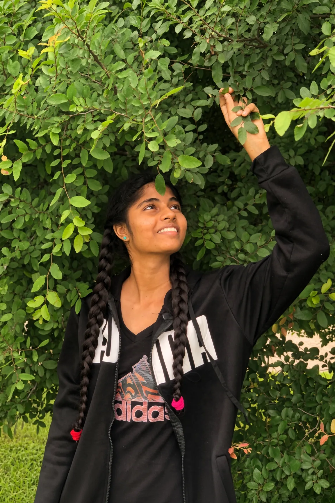 A SpineHope patient reaching up into a tree
